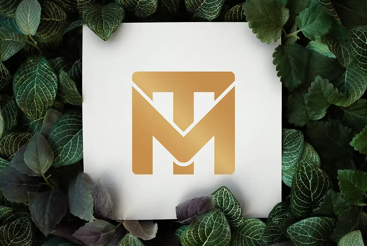 Mockup showing the new TM Maintenance Services icon only on a sign surrounded by leaves